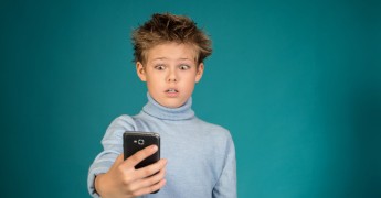 Shocked child using smartphone